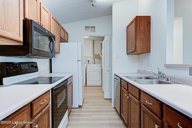 kitchen with black microwave, range with electric stovetop, a sink, visible vents, and dishwasher