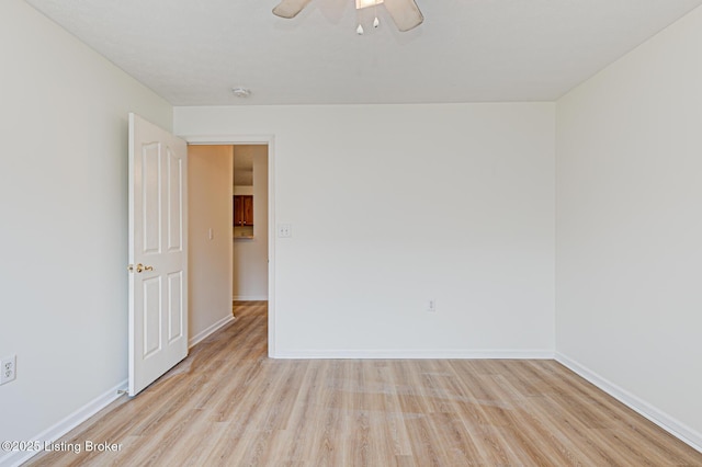 unfurnished room with light wood-type flooring, ceiling fan, and baseboards