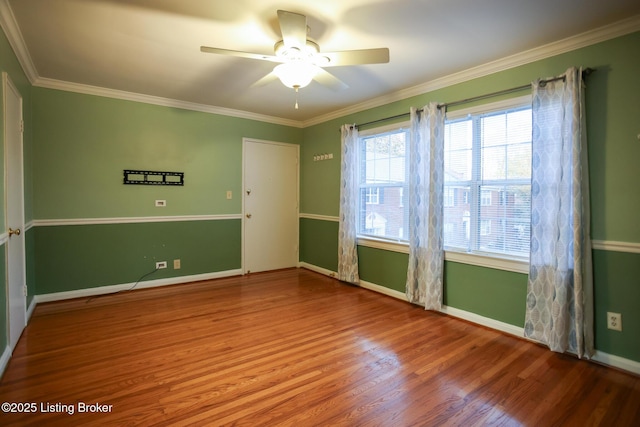 spare room with crown molding, ceiling fan, and wood-type flooring