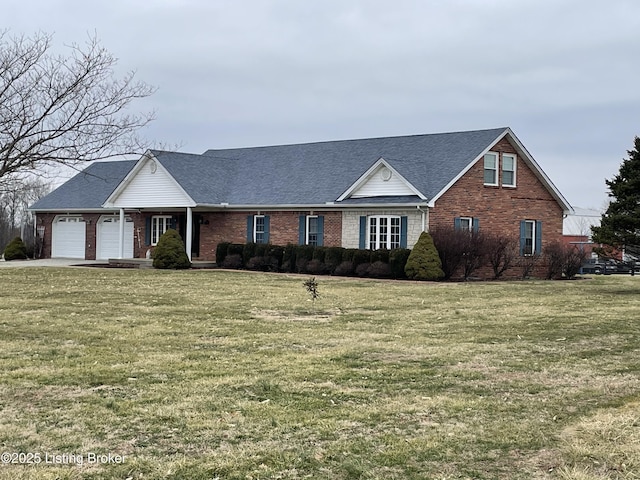 view of front of house with a garage and a front lawn