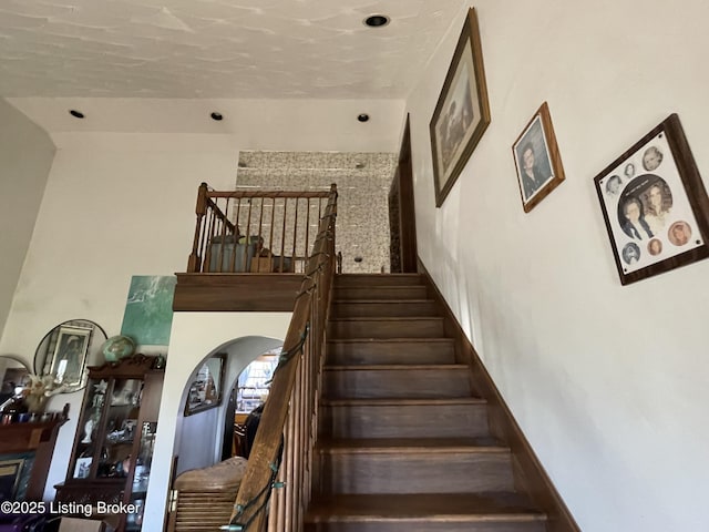 stairway with a fireplace