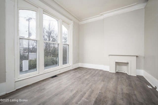 unfurnished living room featuring crown molding and dark hardwood / wood-style floors