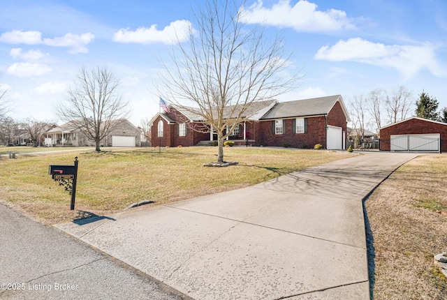 ranch-style home featuring an outbuilding, a garage, and a front lawn