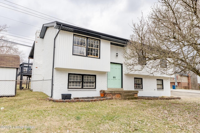 split foyer home with a front lawn