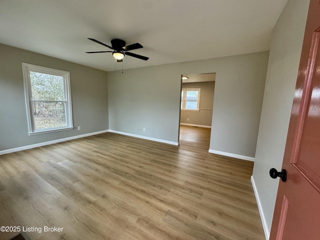 spare room with ceiling fan and light wood-type flooring