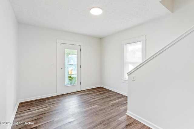 4145 W Muhammad Ali Blvd, Louisville, KY 40212 - spare room featuring plenty of natural light, hardwood / wood-style floors, and a textured ceiling