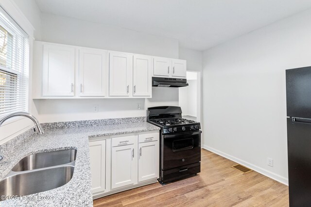4145 W Muhammad Ali Blvd, Louisville, KY 40212 - kitchen featuring white cabinetry, sink, light hardwood / wood-style flooring, and black appliances