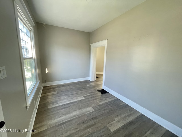 unfurnished room featuring dark hardwood / wood-style flooring