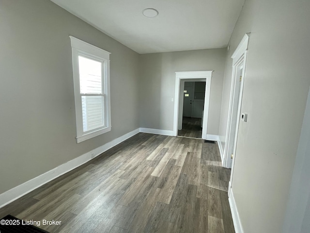 spare room with dark wood-type flooring