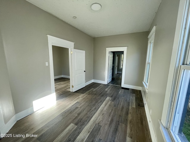 unfurnished bedroom featuring dark hardwood / wood-style flooring