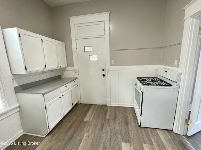 kitchen featuring white cabinetry, white gas range, and light hardwood / wood-style floors