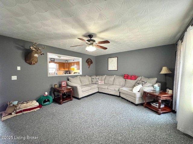 carpeted living room featuring a textured ceiling and ceiling fan