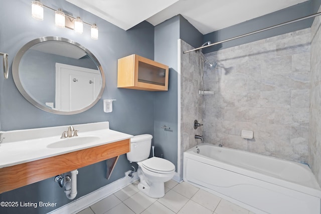 bathroom with tile patterned floors, toilet, tub / shower combination, and a sink