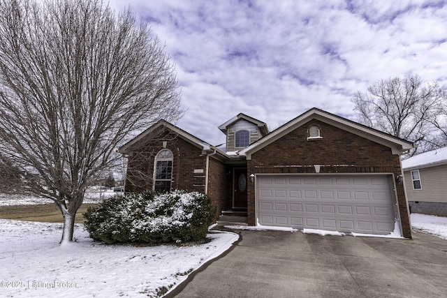 view of front of home with a garage, brick siding, and driveway