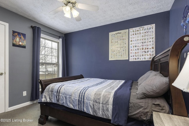 carpeted bedroom with ceiling fan, a textured ceiling, and baseboards