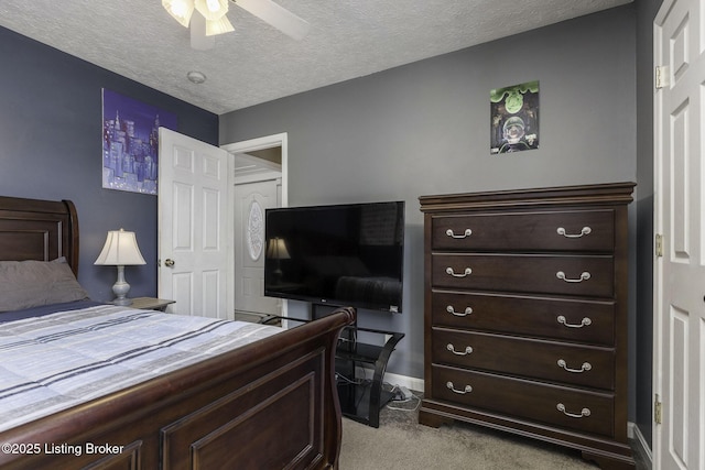 bedroom with a ceiling fan, light colored carpet, a textured ceiling, and baseboards