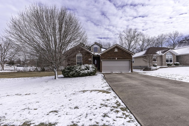 view of front facade with a garage, aphalt driveway, and brick siding