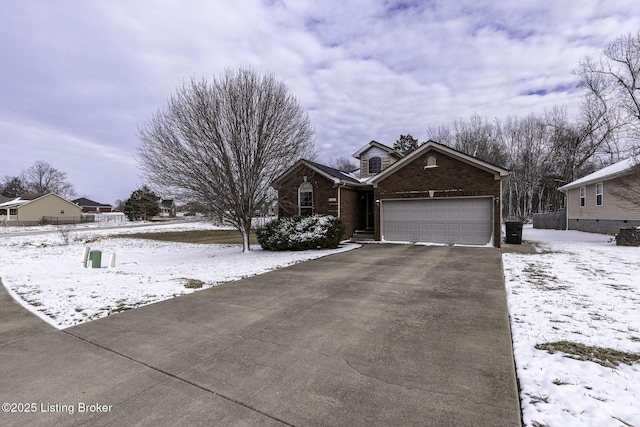 view of front of house with a garage, brick siding, and aphalt driveway