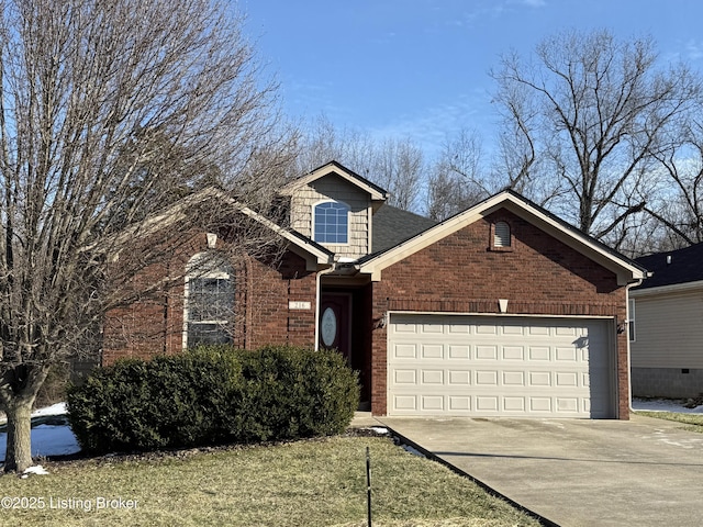 view of front of home with driveway, an attached garage, and brick siding