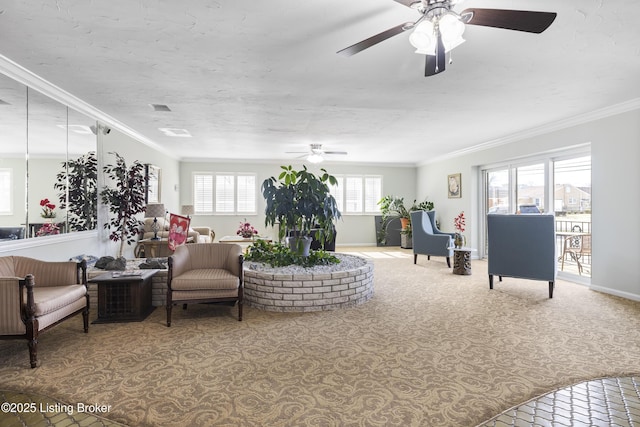 living room with ceiling fan, ornamental molding, and carpet flooring