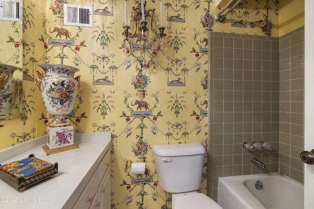 full bathroom with vanity, toilet, and tiled shower / bath combo