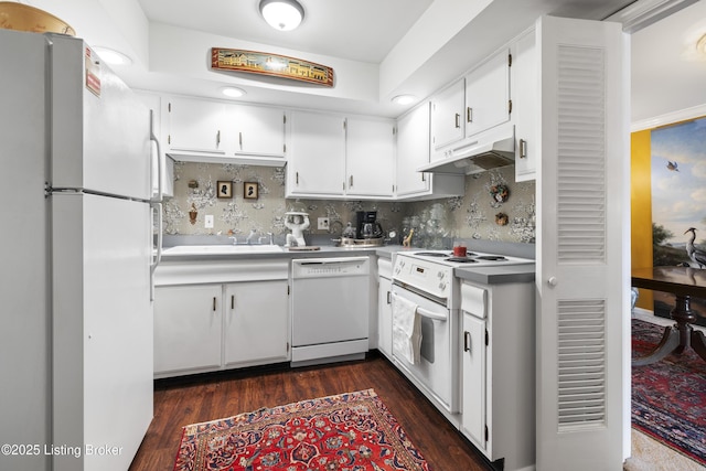 kitchen featuring dark wood-type flooring, sink, white cabinetry, white appliances, and backsplash