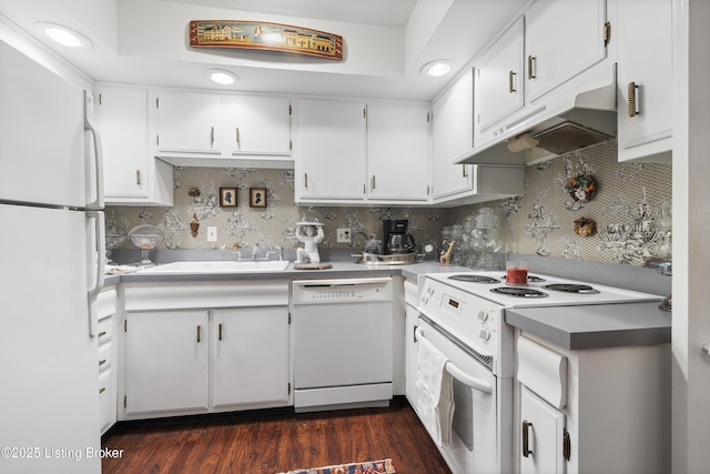 kitchen with white cabinetry, white appliances, sink, and tasteful backsplash