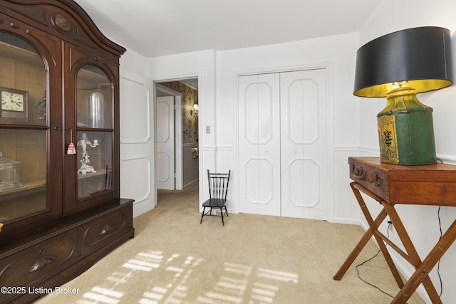 bedroom with light colored carpet and a closet