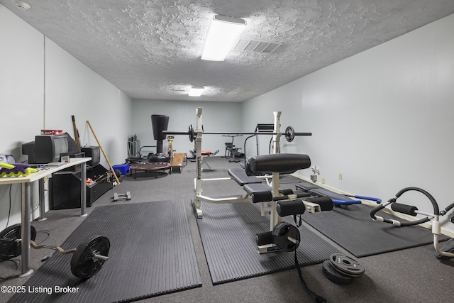 workout area featuring a textured ceiling