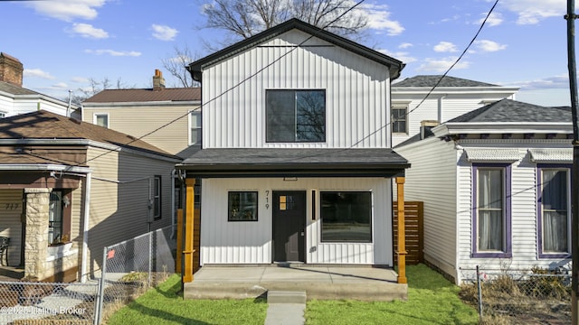 modern inspired farmhouse with board and batten siding, covered porch, fence, and a shingled roof