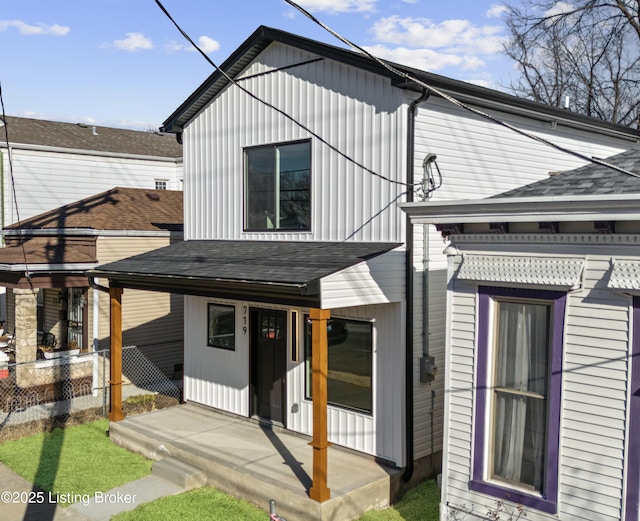 view of front of house with fence and roof with shingles