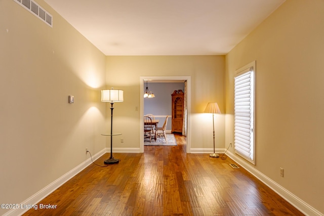 spare room with plenty of natural light and wood-type flooring