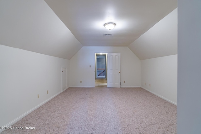 additional living space with light carpet and lofted ceiling