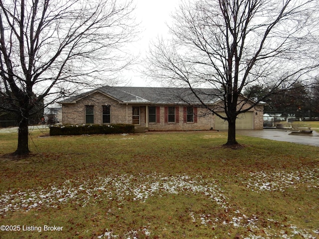 ranch-style house featuring a garage and a front lawn