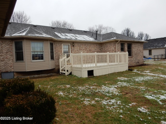 rear view of house featuring a yard and a deck