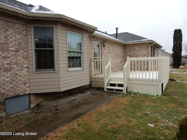 view of property exterior featuring a yard and a deck