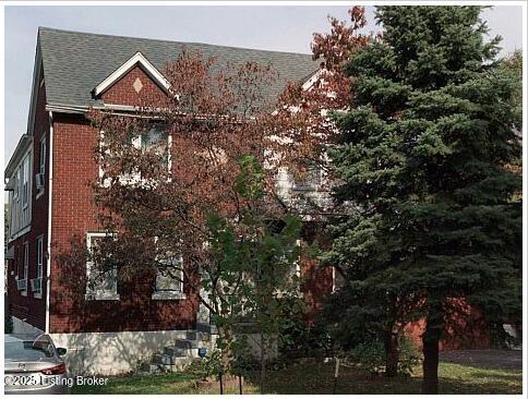 view of side of property with brick siding