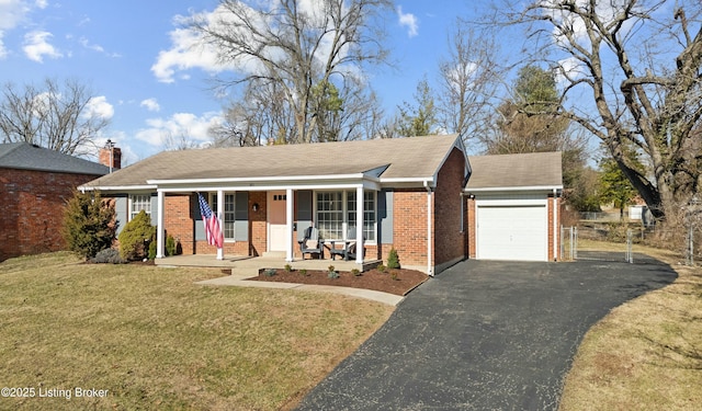 view of front of house featuring a garage, covered porch, and a front yard