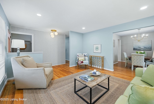 living room with an inviting chandelier and wood-type flooring