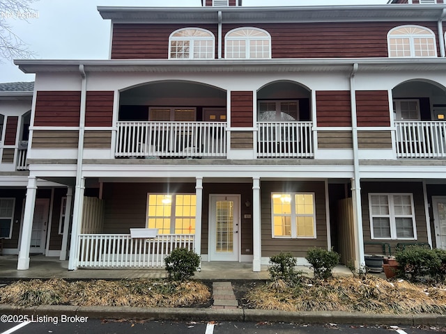 townhome / multi-family property featuring a porch