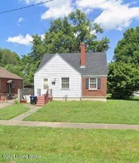 exterior space featuring a front lawn and a chimney