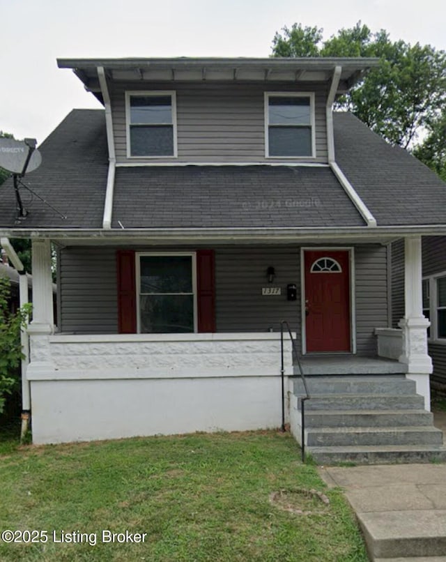 view of front of property featuring covered porch and a front lawn