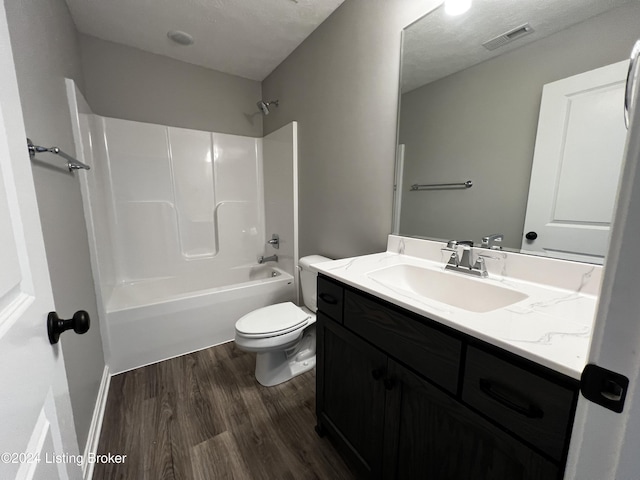 full bathroom featuring vanity, hardwood / wood-style floors, toilet, and shower / bath combination