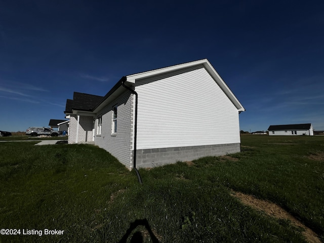 view of home's exterior with a lawn