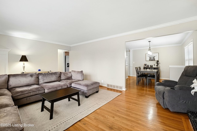 living room featuring hardwood / wood-style floors and ornamental molding