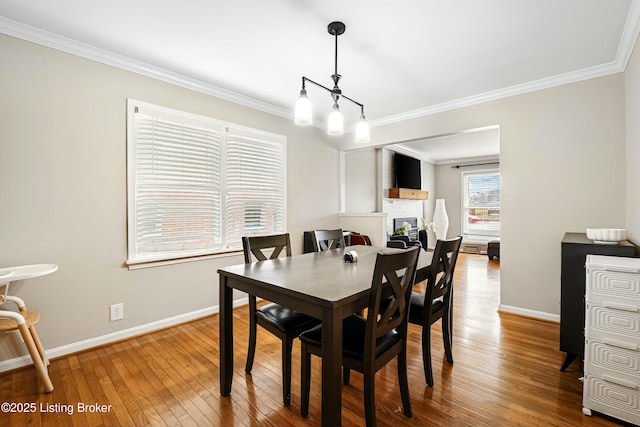 dining area featuring hardwood / wood-style flooring and ornamental molding