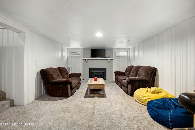 living room featuring a fireplace and carpet flooring