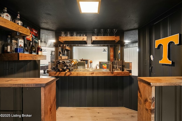 bar with light wood-type flooring