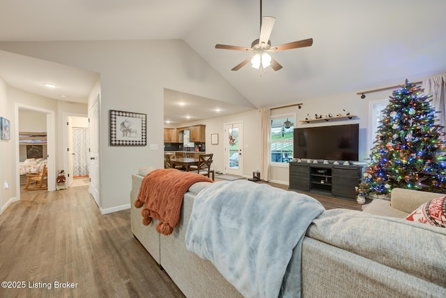 living room with high vaulted ceiling, hardwood / wood-style floors, and ceiling fan