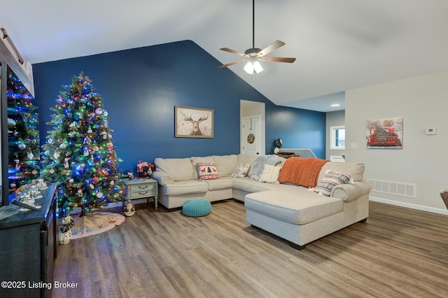 living room with lofted ceiling, hardwood / wood-style floors, and ceiling fan